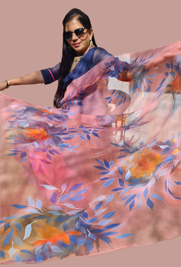 Woman holding a hand painted floral pink dupatta.