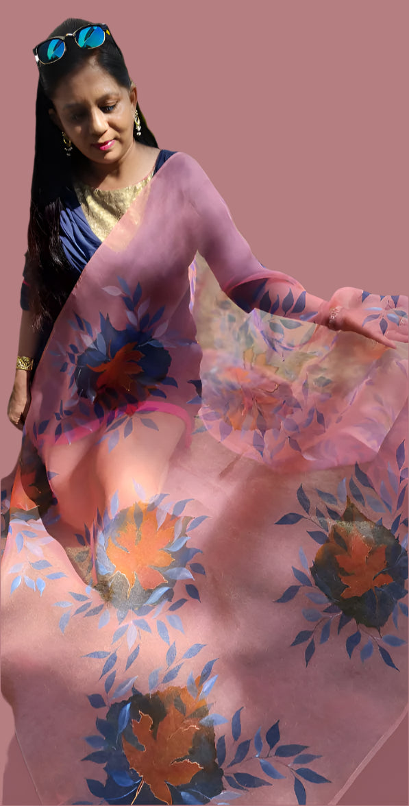 Woman holding a hand painted floral pink dupatta.