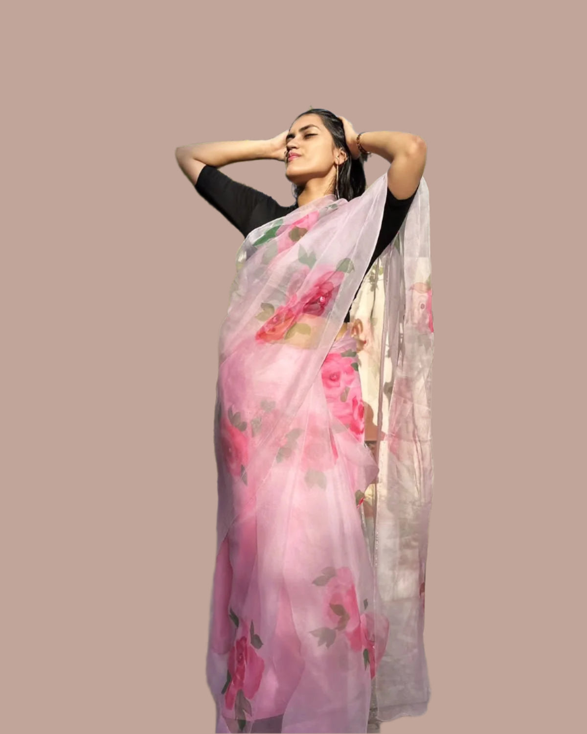 Woman wearing a hand painted pink floral saree.