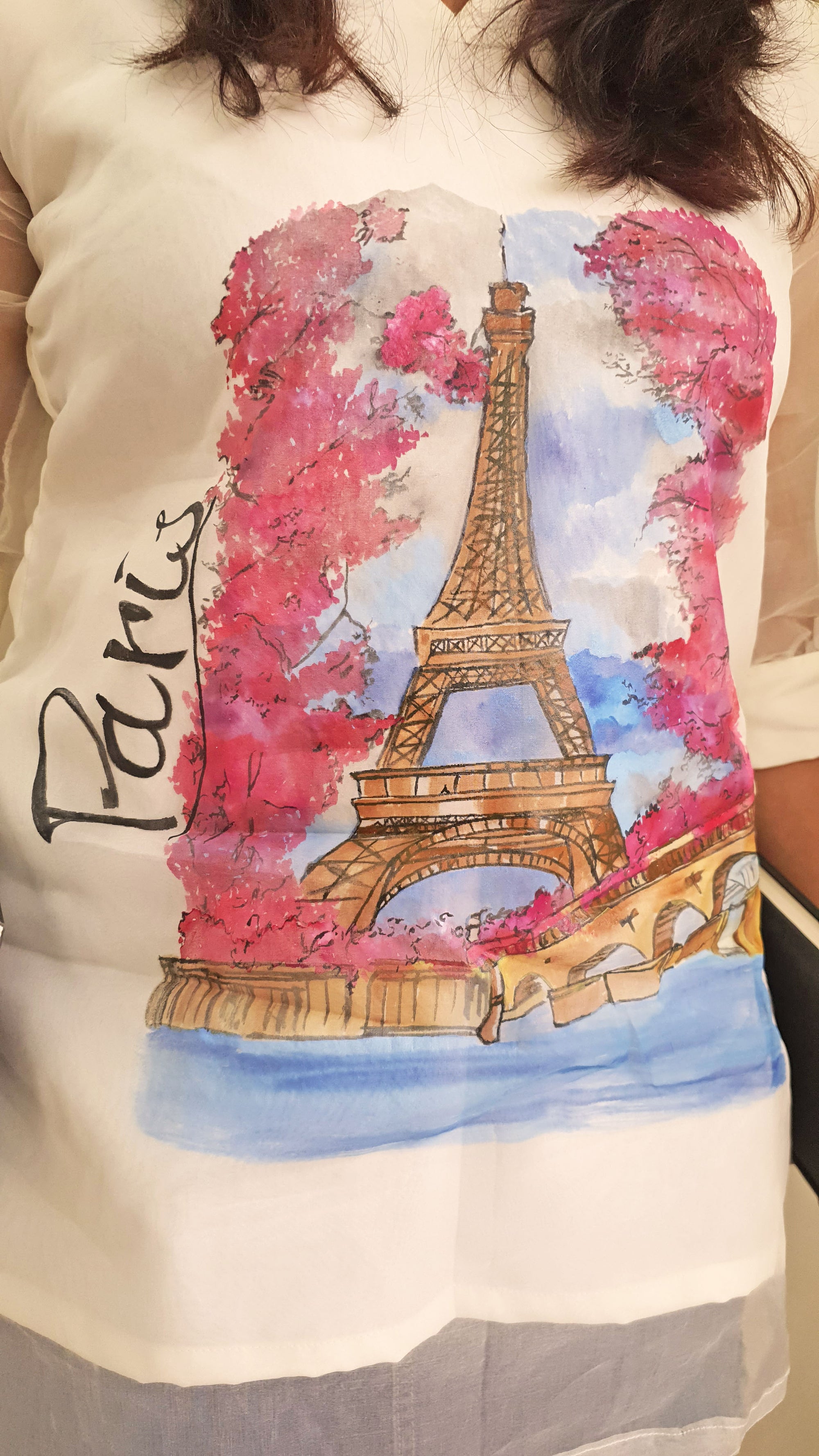 shirt with a colorful Eiffel Tower design and 'Paris' text on a white background.