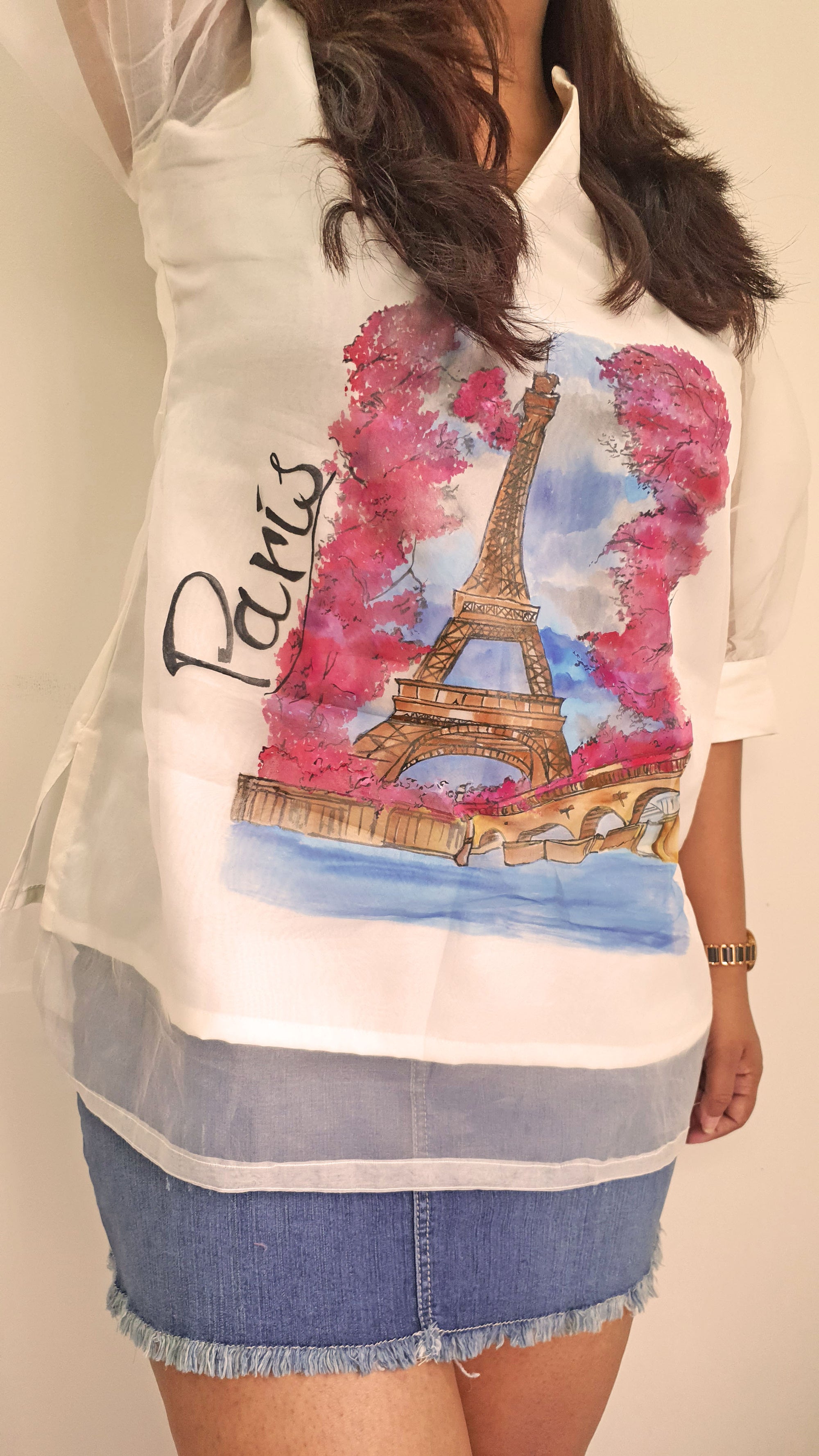 Person wearing a top with a Paris-themed design featuring the Eiffel Tower.